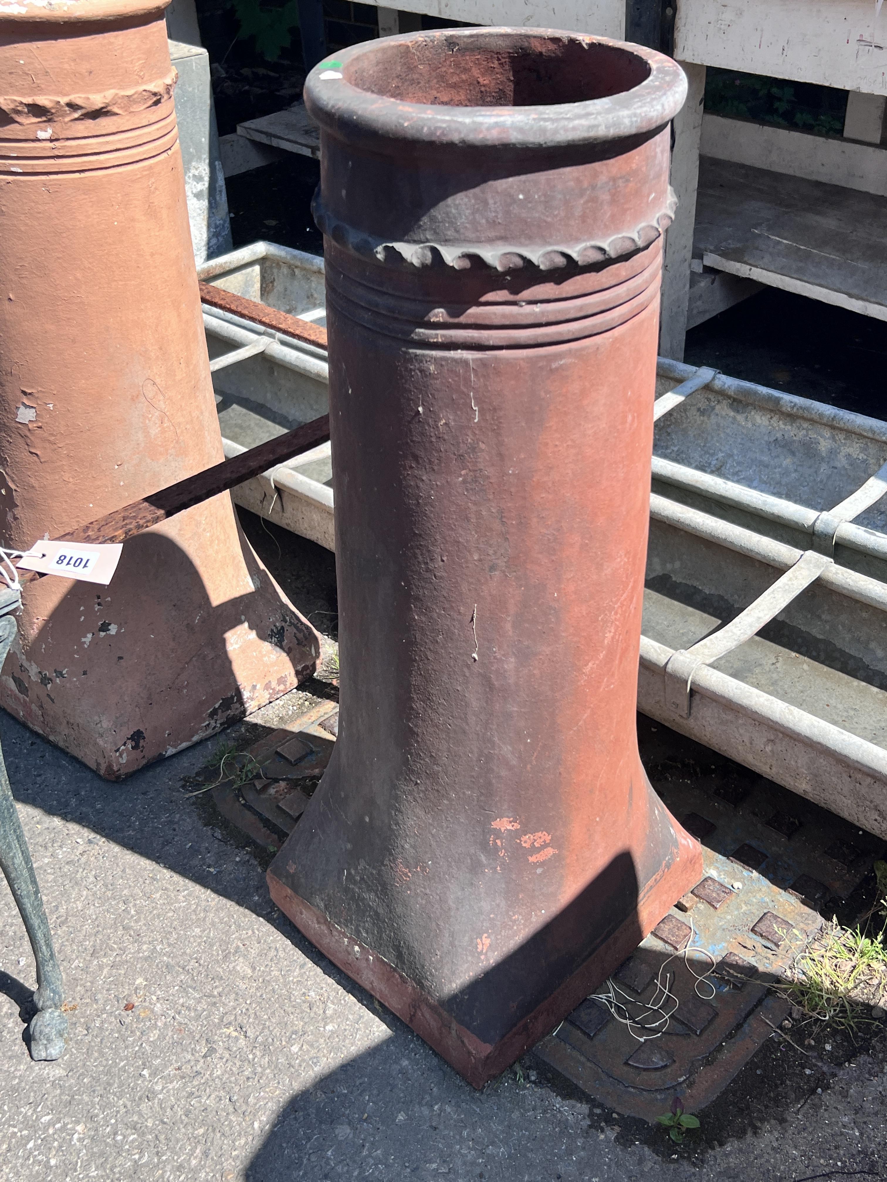 Two terracotta chimney pots, height 77cm, together with a square metal table frame